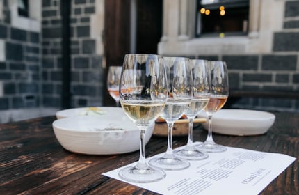 Row of wine tasting glasses outside on a table at Cellar Door in Christchurch.