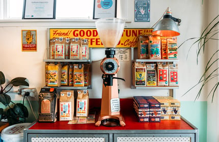 Coffee machine and bags of coffee on a colourful counter in Miss Fortune's cafe
