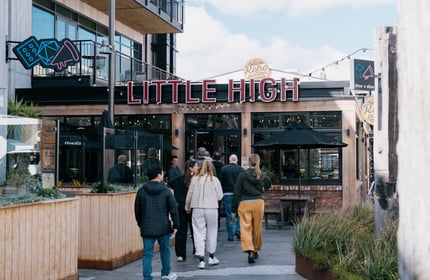 Group walking into the entrance of Little High Eatery in Christchurch