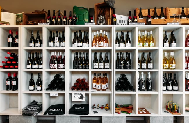 Multiple rows of shelves of wine at Ōhau Wines.