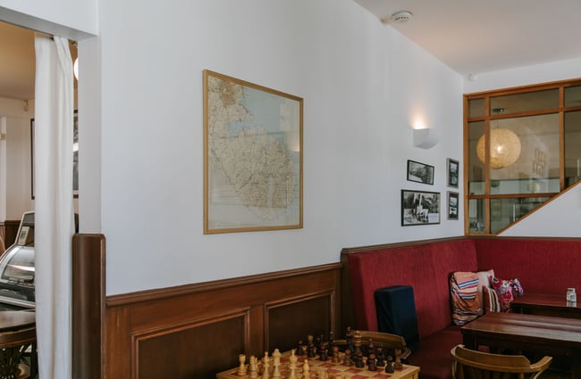 Big wooden chess board with bench seating at Ōtoromiro Hotel, Governors Bay.