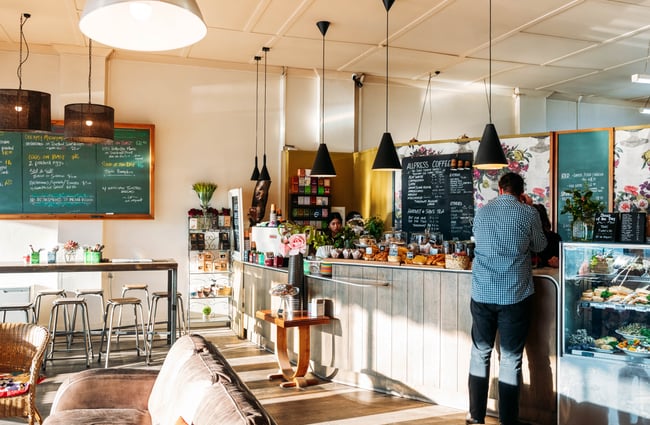 A customer ordering the counter at The colourful interior of 103 The Store Roxburgh Central Otago.