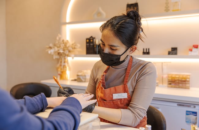 CLose up of nail artist in the middle of a manicure at 1999 House of Nails Ferrymead.