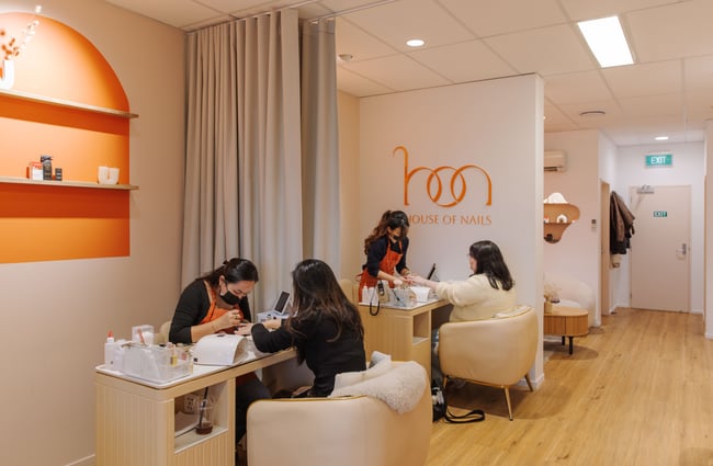 Nail technicians doing manicures on clients at 1999 House of Nails - Manchester Street.