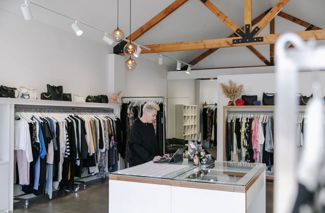 A female employee working at the counter in 47 Frocks.