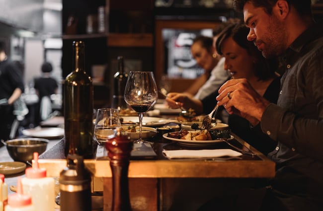 A man cutting food on his plate at 5th Street restaurant Christchurch.