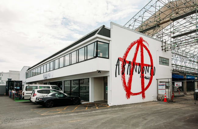 The side of the Abandoned Brewery with there logo on the side of the building.