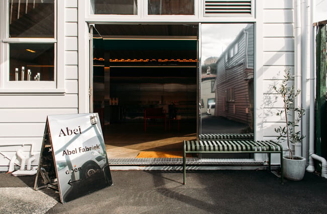 The exterior of the elegant Abel building with a white weatherboard outside.