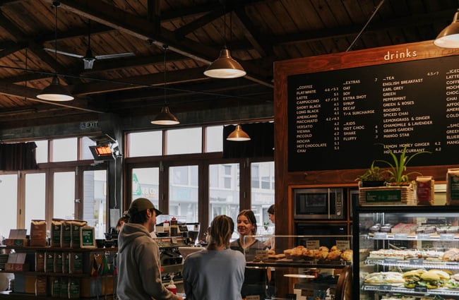 Customers standing by the till at Addington Coffee Co-op in Christchurch.