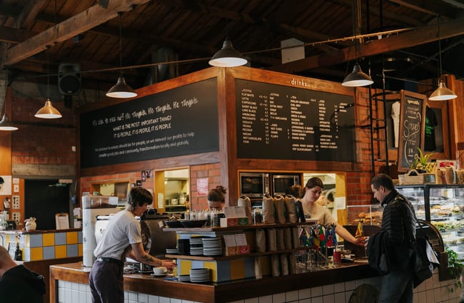 People standing at the counter at Addington Coffee Co-op in Christchurch.