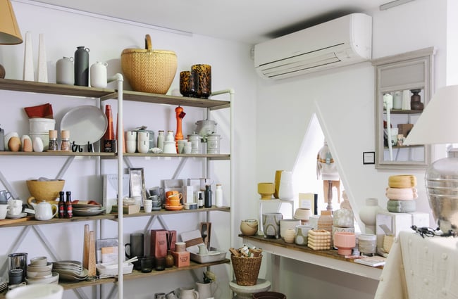 Lots of homewares on table and shelves.