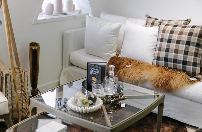 Sofa and glass coffee table on display.