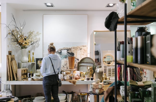Woman looking at homewares inside Addy & Lou.