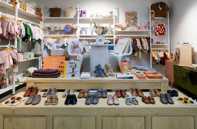 Baby shoes, clothes, and books on display.