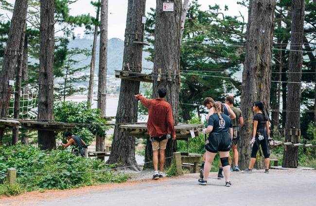 People prepare to climb the ropes.