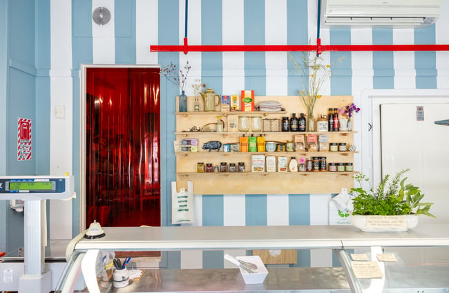 Cute blue and white striped wall at Akaroa Butchery with lots of local products on shelves