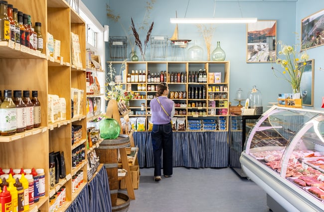 Person standing in front of shelves of local products at Akaroa Butchery & Deli
