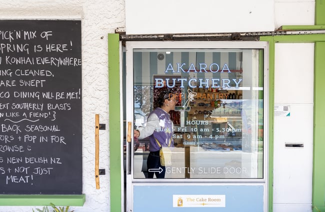 Someone sliding open door to Akaroa Butchery