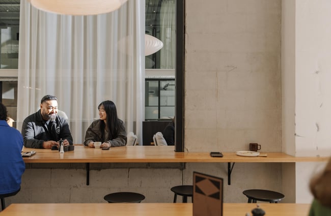Customers sitting at a table at Akin.