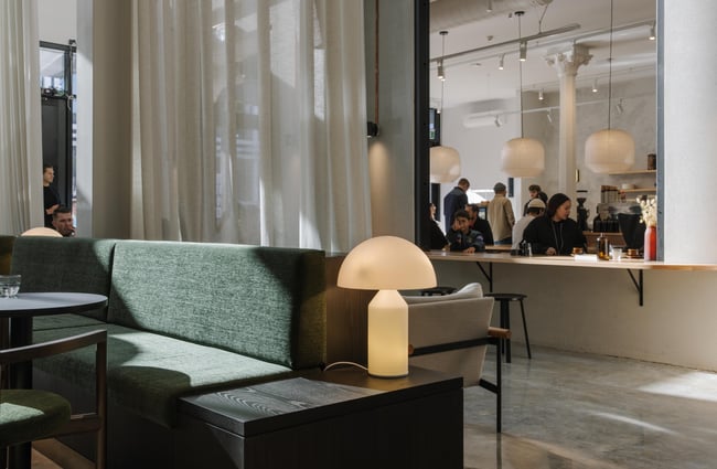 Dark green sofa with view of the cafe at Akin.