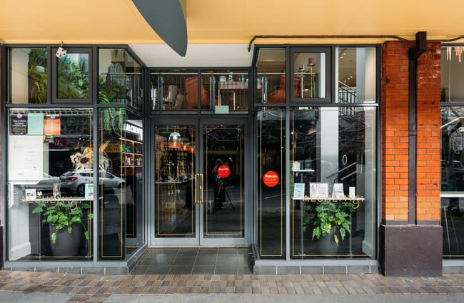 The glass and brick entrance to Alchemy and I in Palmerston North.