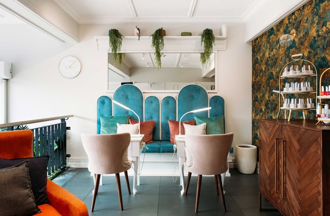 The blue and white decorated nail bar inside Alchemy & I.