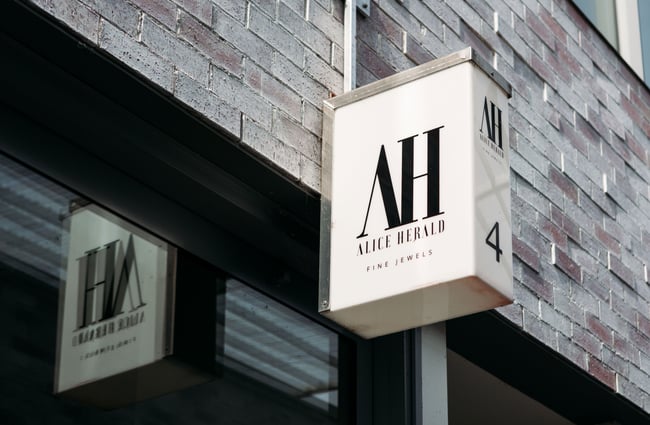 A close up of a Alice Herald sign on an exterior wall.