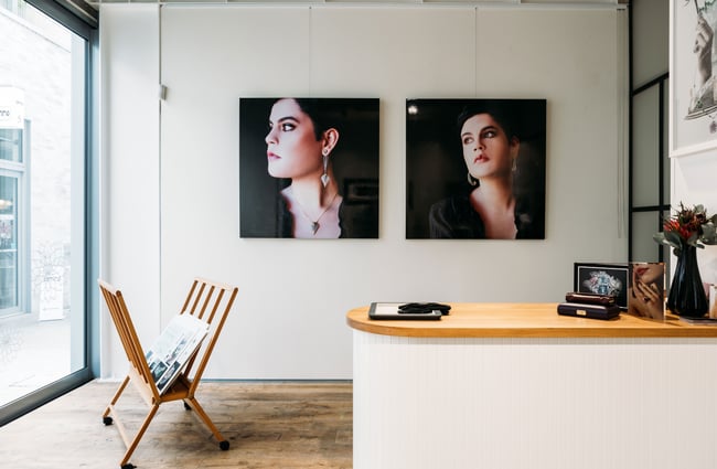 Two photos on a shop wall of a woman wearing diamond jewellery.