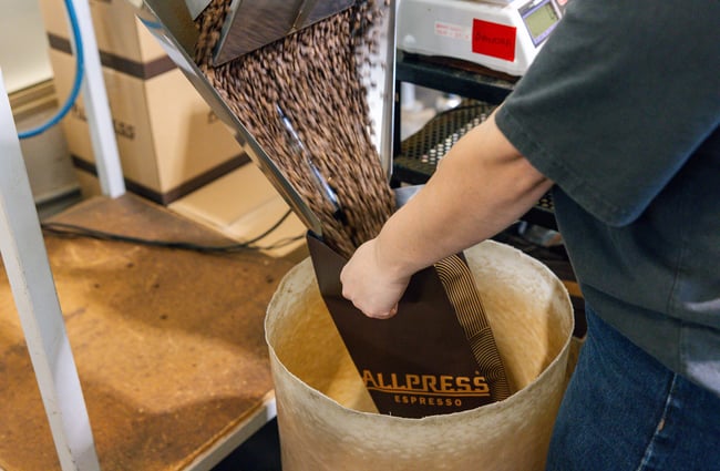 Coffee beans pouring from machine at Allpress Auckland Roastery