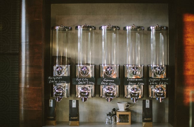 A row of coffee bean dispensers.