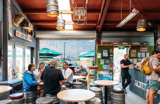 People dining inside a brewery bar.