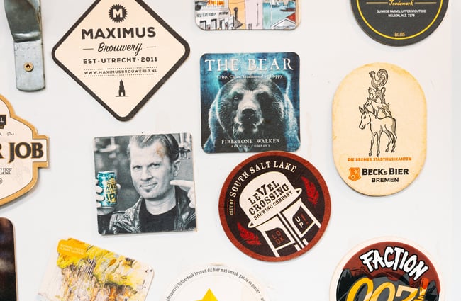 Beer coasters on a fridge.