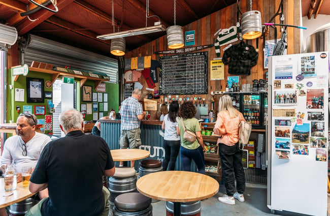 Customers lined up waiting to be served at a counter.