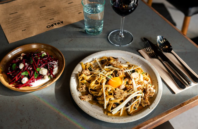 A close up of two plates of food on a table.