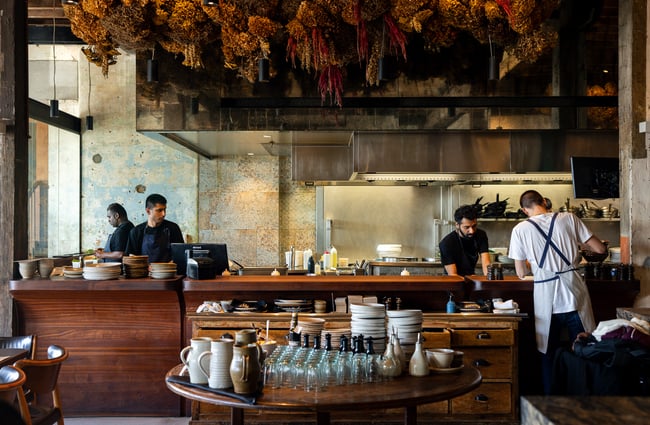 Staff members working behind a bar counter.