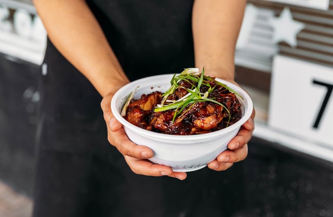 Dish being held by staff member at An Nyeong Ha Se Yo Korean Food Takeaway.
