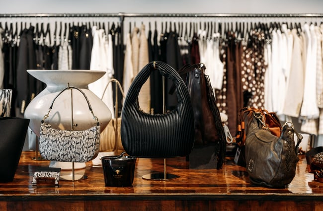 A black bag on a table inside a fashion store.