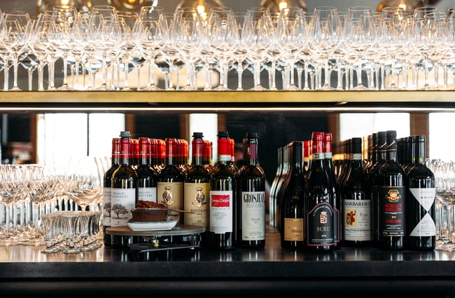 Bottles of red wine lined up in a row.