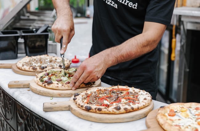 Close up of slicing fresh pizza at Arbour in Lyttelton.