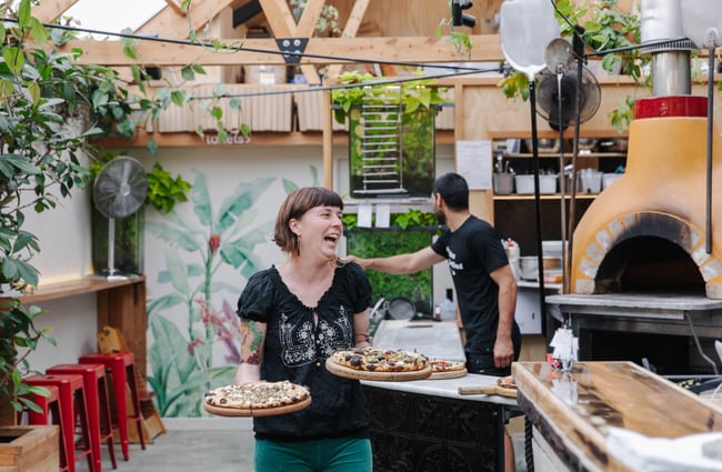 Megan holding pizzas at Arbour in Lyttelton.