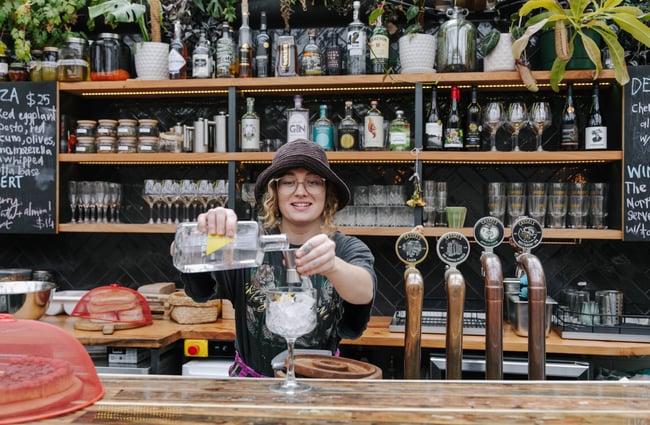 Woman making G&T behind the bar at Arbour in Lyttelton.