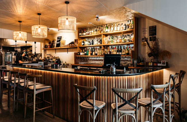 Timber-lined bar area inside arc, Wānaka.