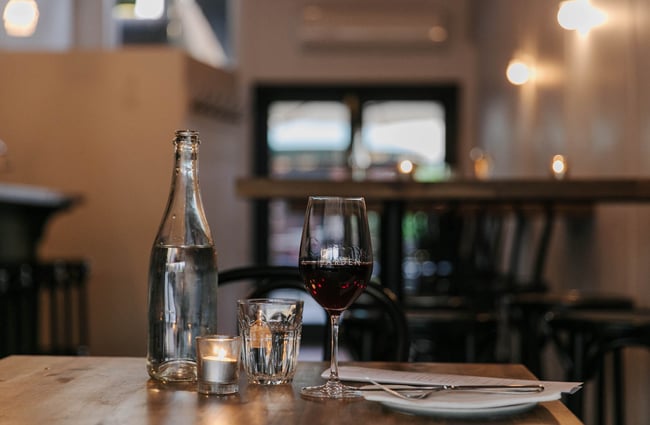 Glass of red wine on a table at Arden.