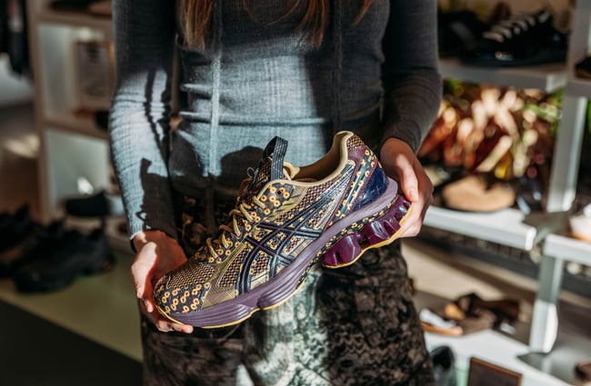 Close up of a woman holding a sneaker at Area51 in Wellington.
