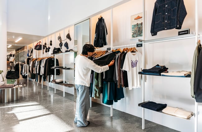 A man looking at clothes at Area51 in Wellington.