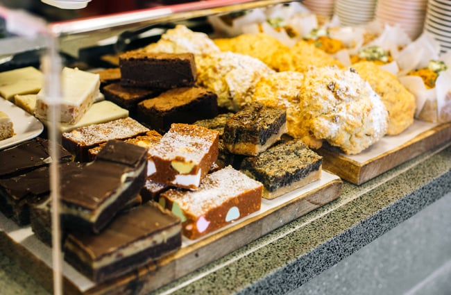 Close up scones and treats in a cabinet.