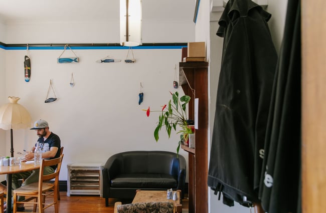 Man sat at a table at Arthur St Kitchen, South Canterbury.