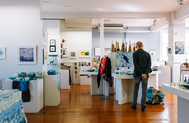 Man looks around ArtsPost Gallery and Shop Hamilton.