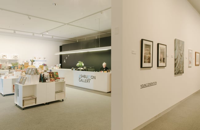 A view of the information desk from inside a gallery space at Ashburton Art Gallery.