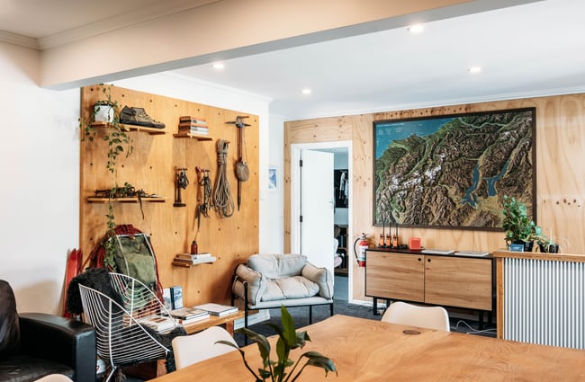Reception area with map on the wall and other equipment at Aspiring Guides.